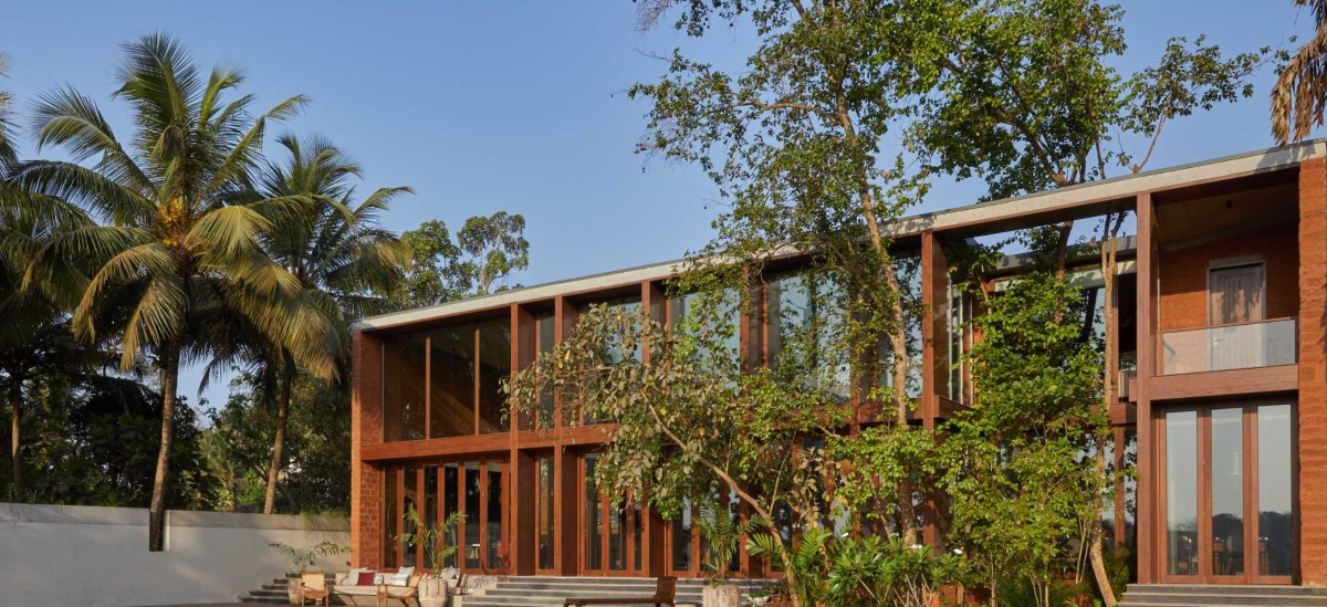 Riverside View of House of Multiple Courts by Sameep Padora & Associates