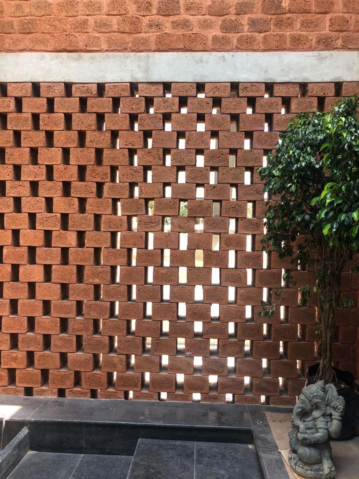 Detailed shot of Laterite stone screen of House of Multiple Courts by Sameep Padora & Associates