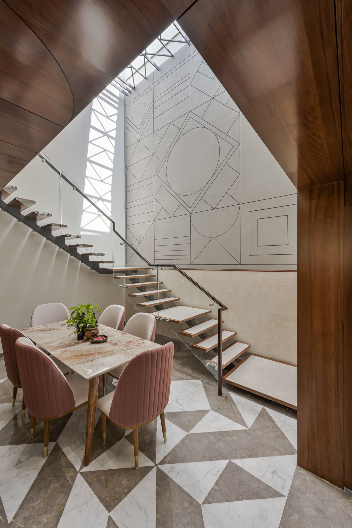 Double height dining has a glorious wall with geometrical play.