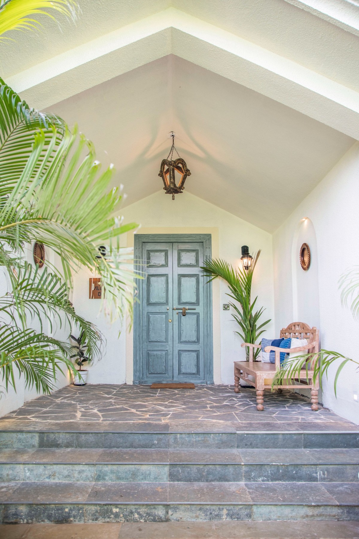 A distinctive blue door welcomes you inside the villa