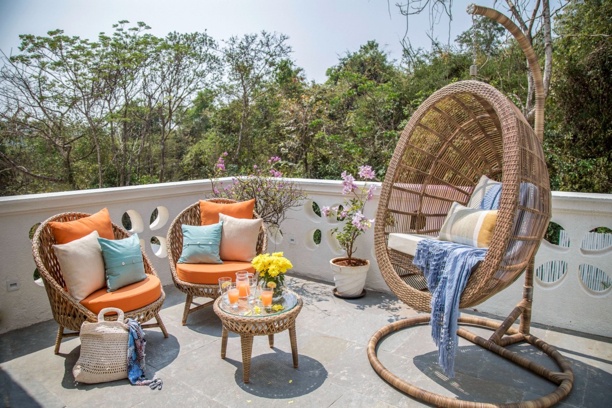 The rooftop is decorated in rattan chairs and swing, adding to the relaxed vibe of the space