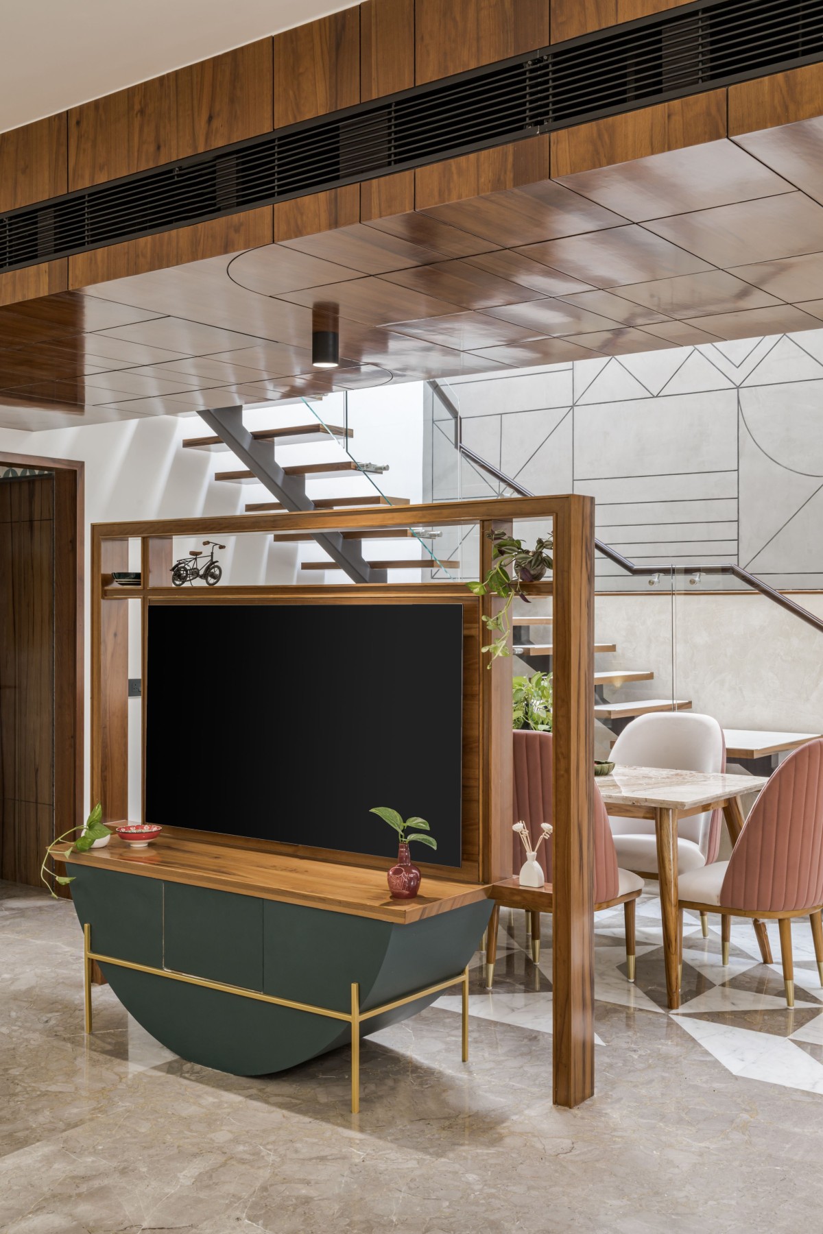 An eclectic TV unit divides the open plan in two parts of public and semi public areas.