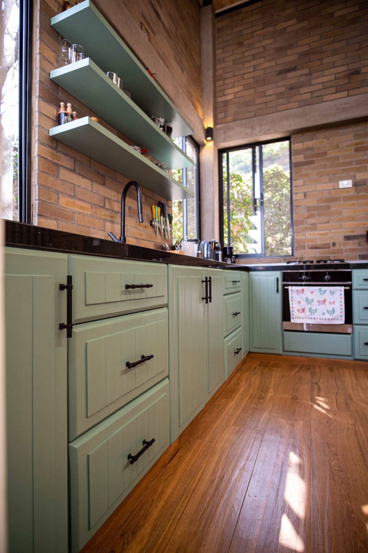 A simple, yet efficient open kitchen that compliments the rustic brown, beige and exposed concrete. making it a stand out feature in this house