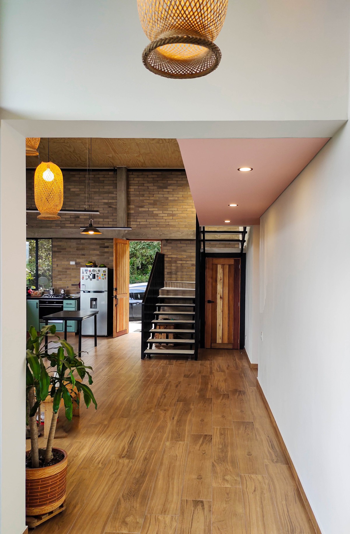 A framed view of the living space, capturing the earthy tones, natural textures and a hint of pink adding to the lightness of the space