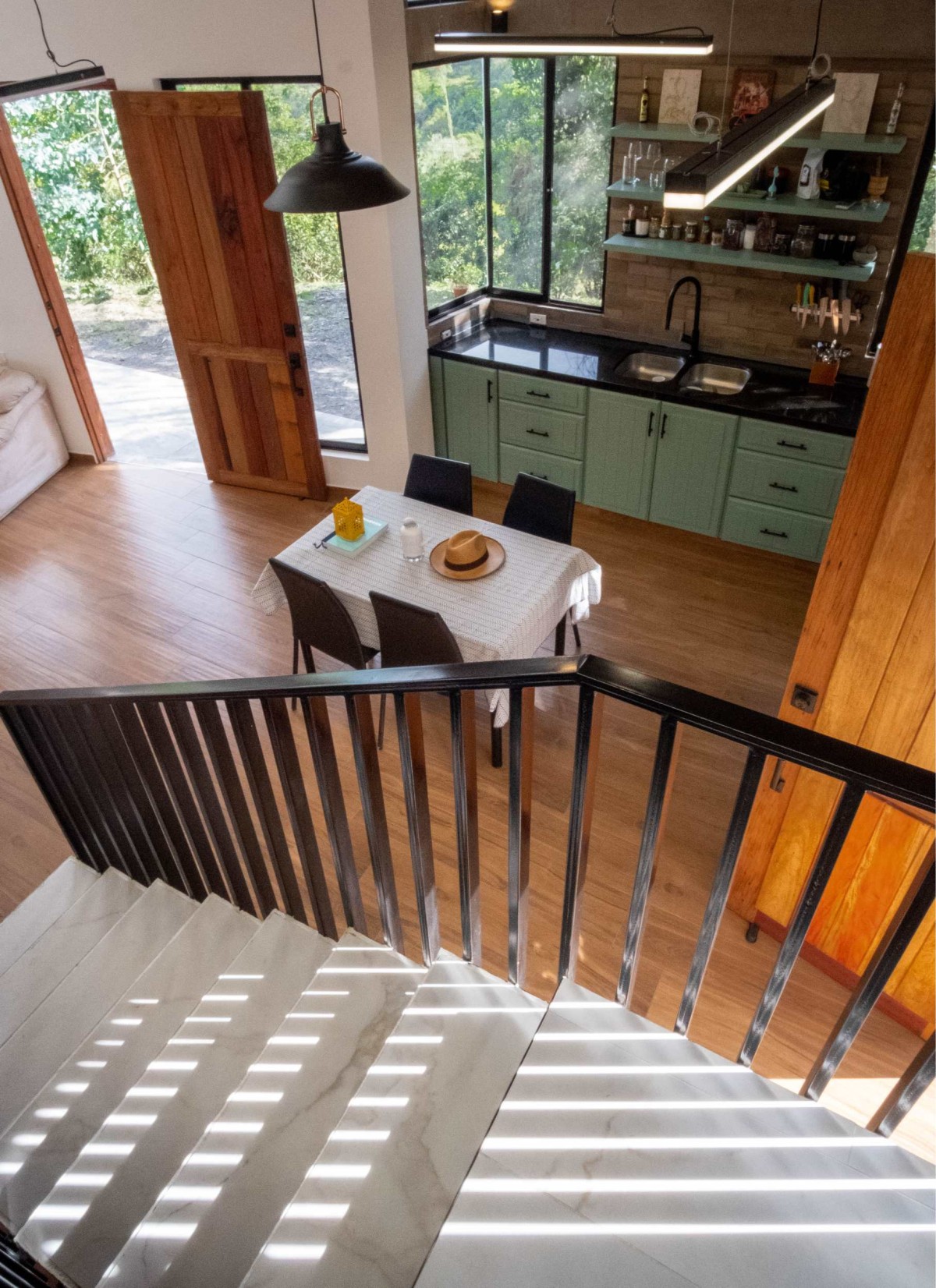 Dining and Kitchen view from staircase of Casa Kambu by Equals To design lab