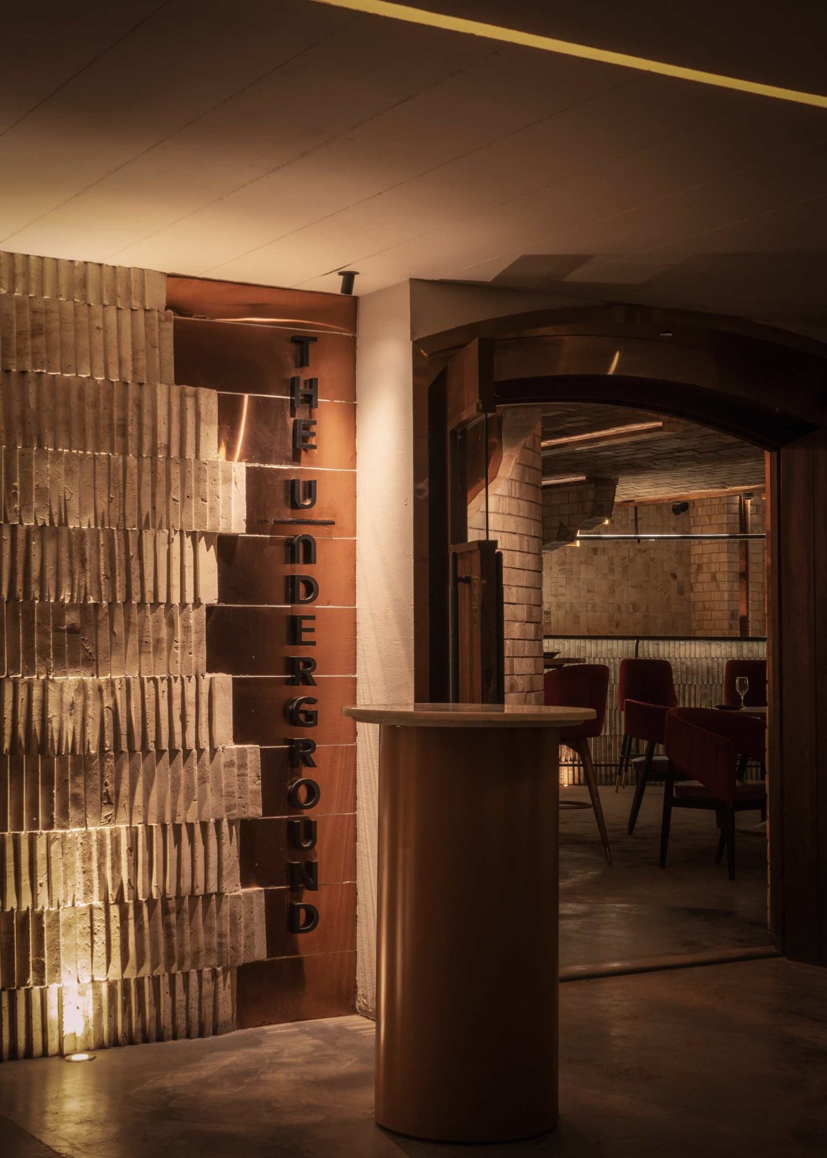 The lobby to the bar features the hero elements - copper and stone bricks in a weaving pattern forming the shell