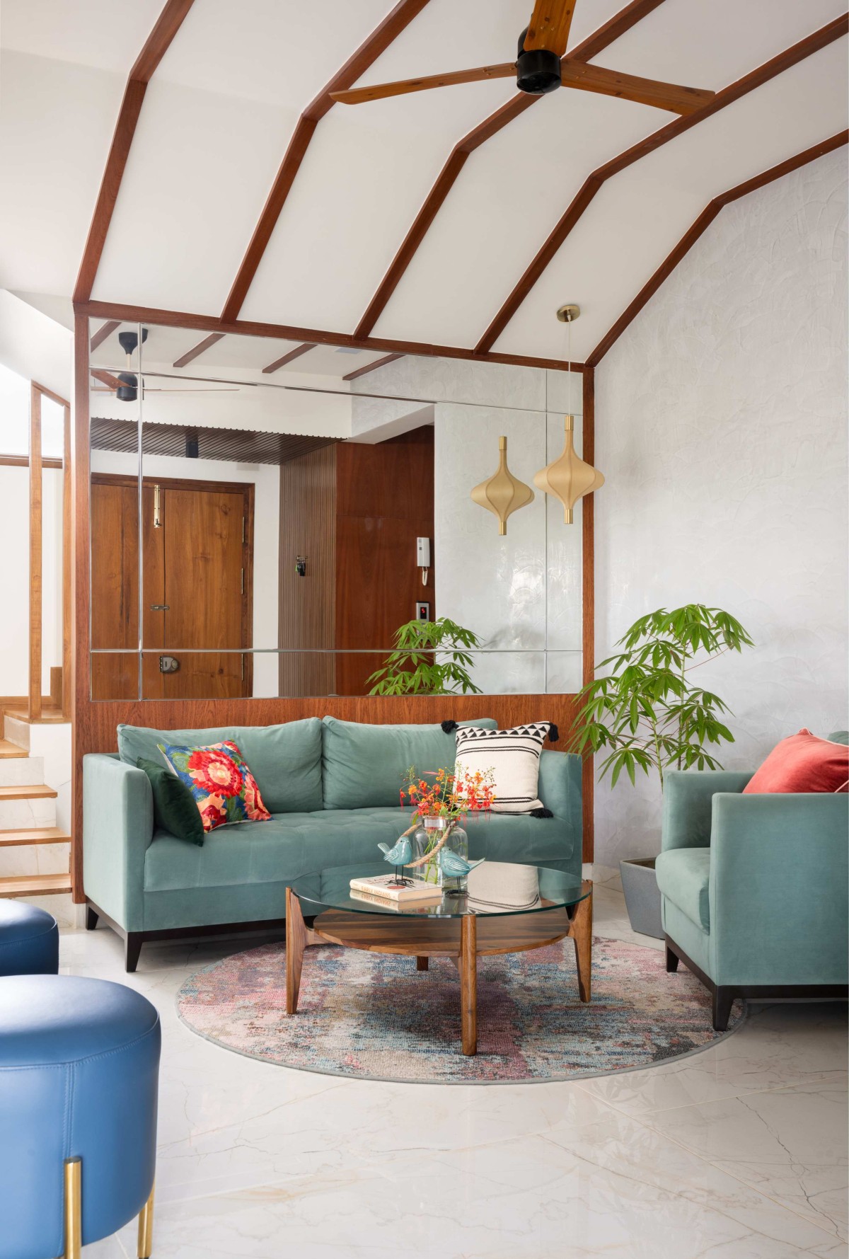 Formal living features intensely hued furnitures and the wooden reaper on the ceiling setting the tone for the rest of the home