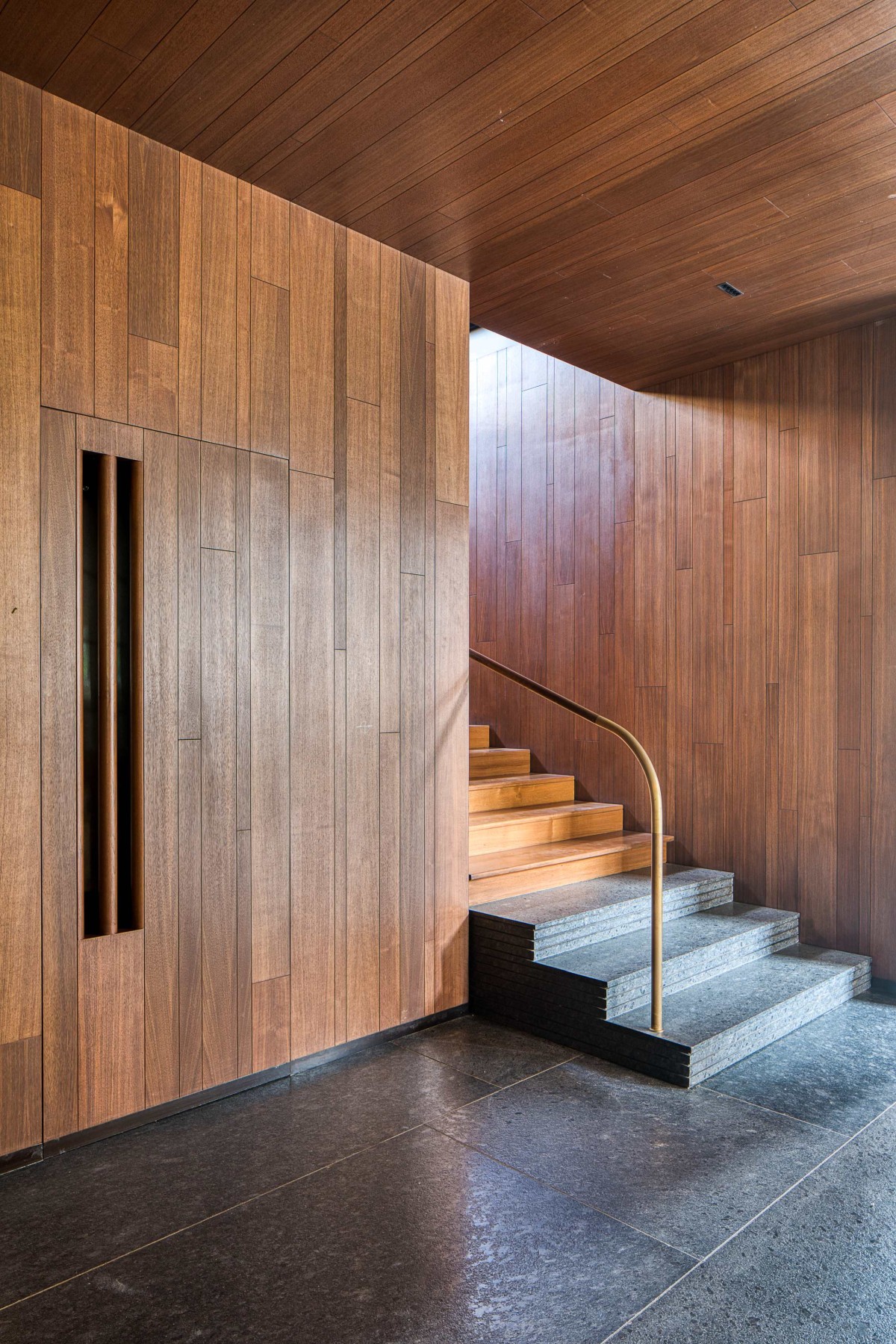 Passage to staircase of Lake Shore House by SPASM Design Architects