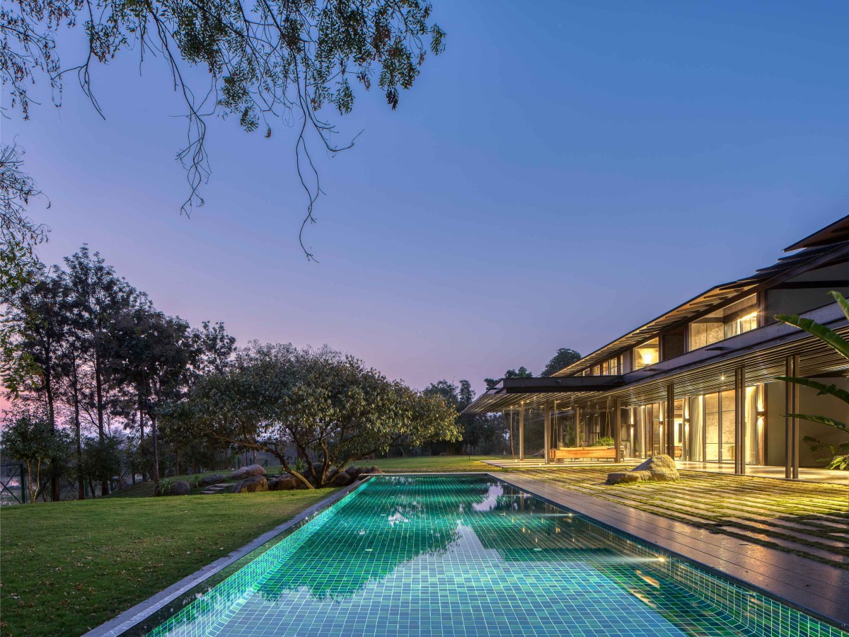 Dusk light pool view of Lake Shore House by SPASM Design Architects