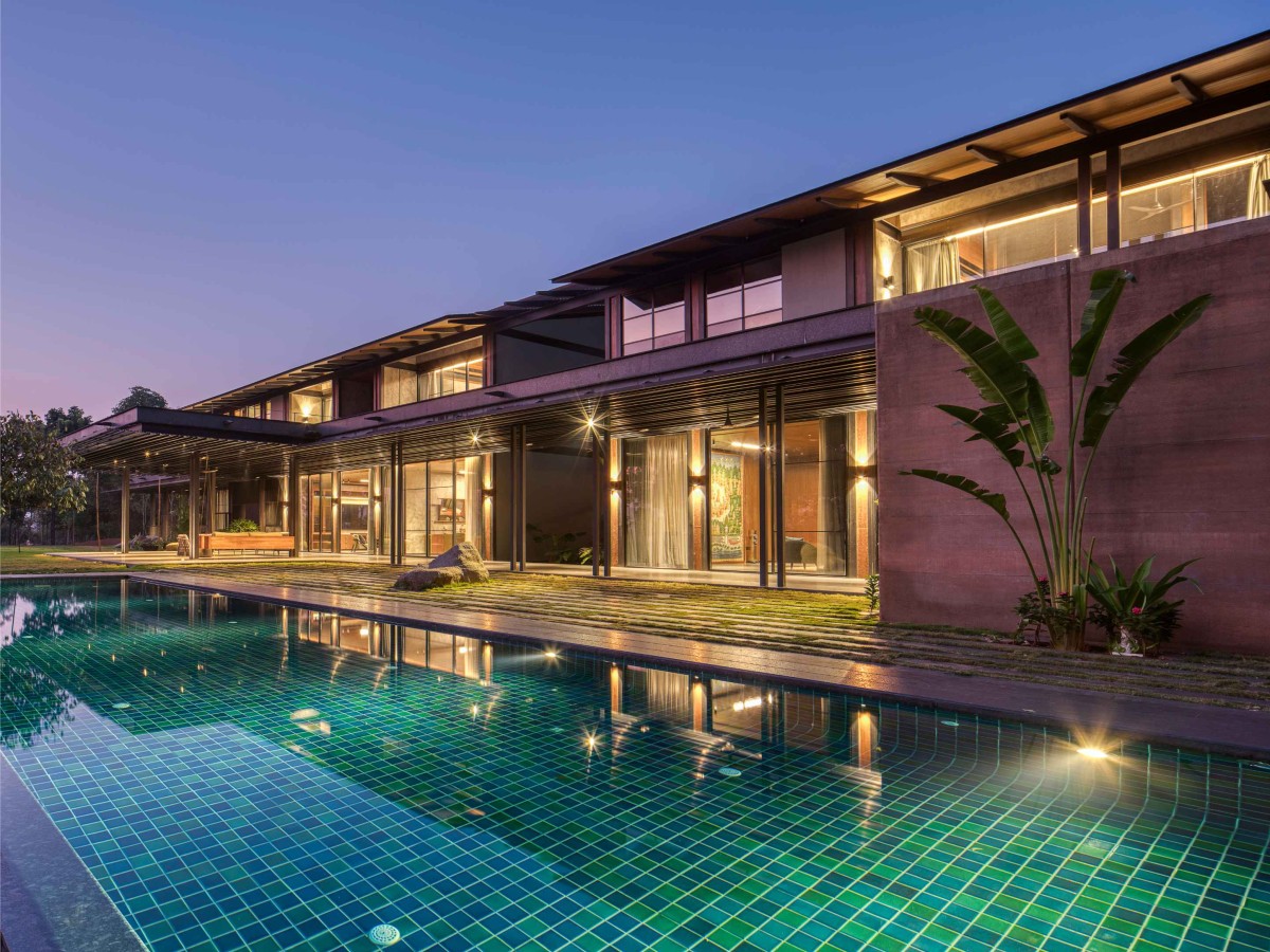 Dusk light pool view of Lake Shore House by SPASM Design Architects