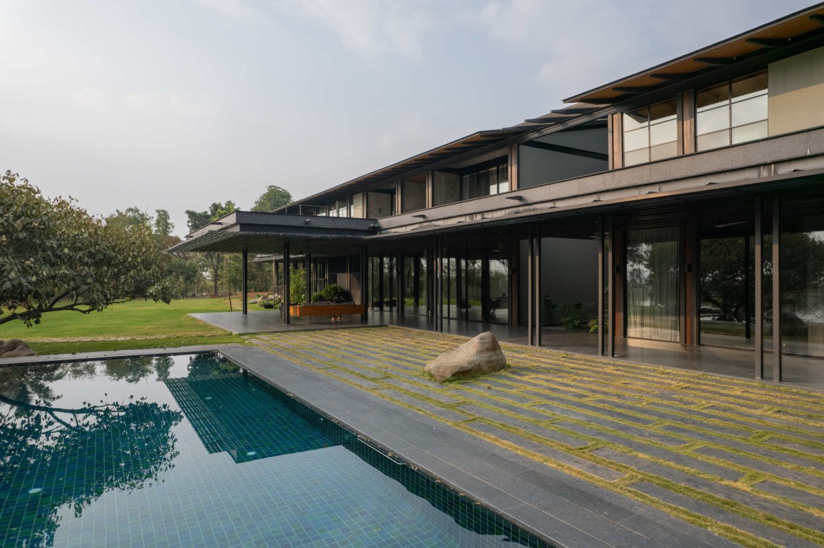 Pool side view of Lake Shore House by SPASM Design Architects