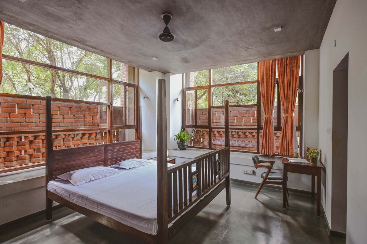 Bedroom with bay windows of Kalarigram House by Badoloka