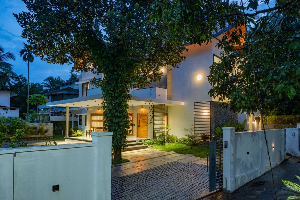 Dusk light exterior view of House Beneath a Jackfruit Tree by Uru Consulting LLP