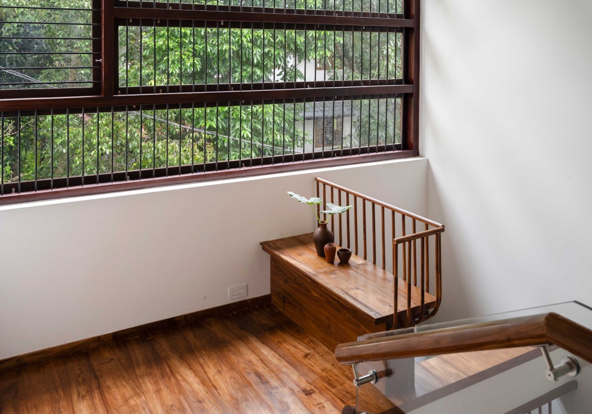 Seating area at staircase of House Beneath a Jackfruit Tree by Uru Consulting LLP