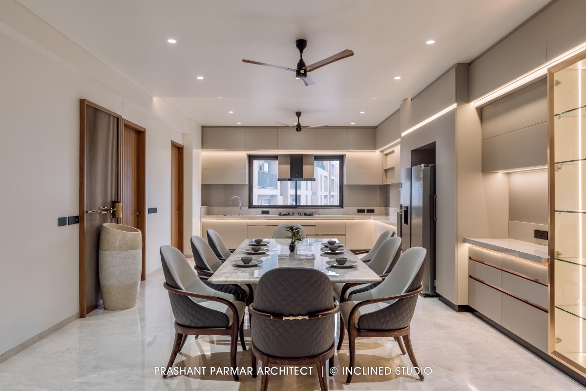 Dining & Kitchen of 4BHK Timeless Interiors at Skara Divyam by Prashant Parmar Architect