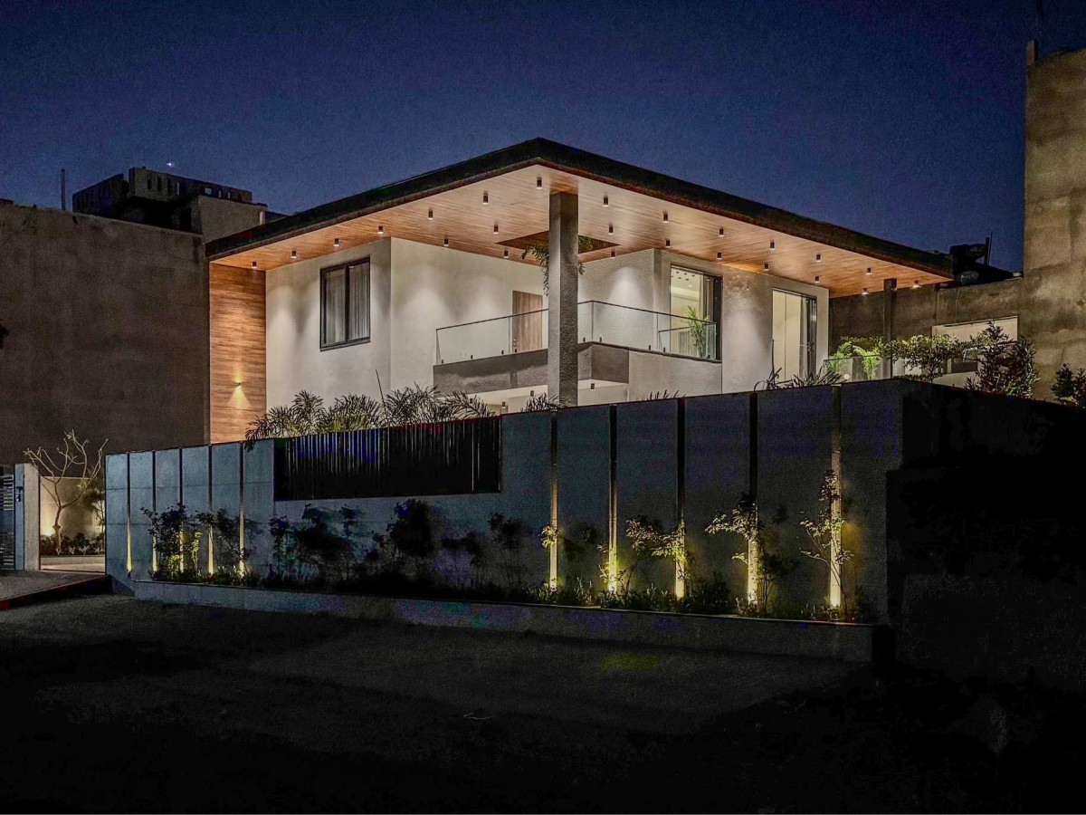 Night exterior view of The Lightwell Farmhouse by Studio Symposium