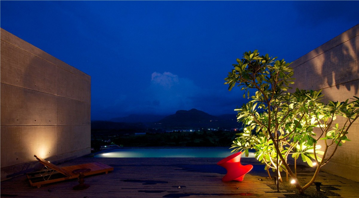 Night shot of swimming pool of The House Cast in Liquid Stone by SPASM Design Architects